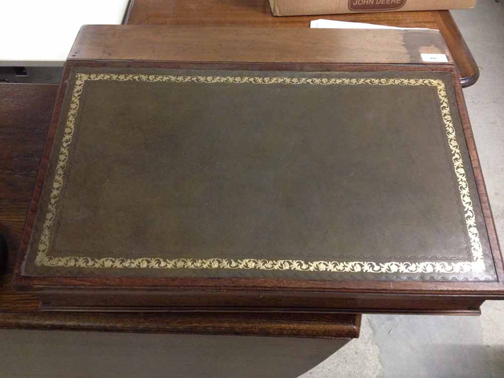 A large writing desk with leather top.