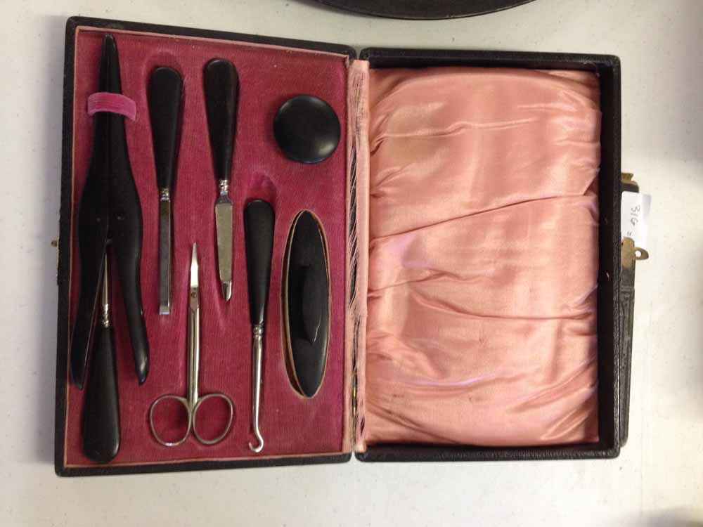 A cased Ebony manicure set.