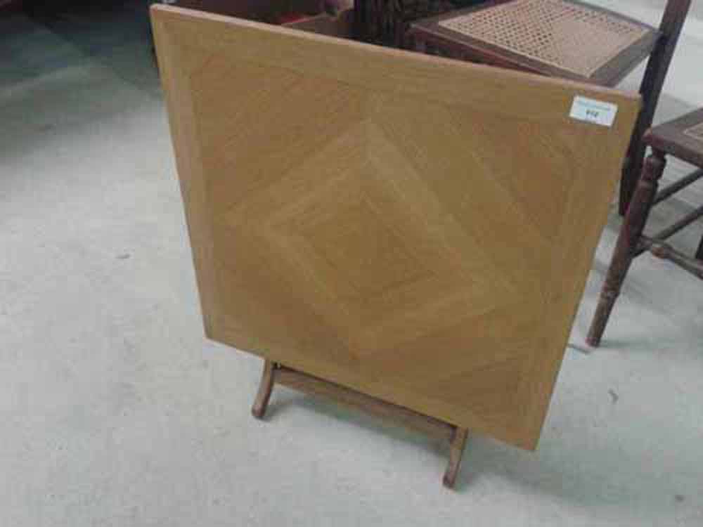 A Meridew folding square coffee table