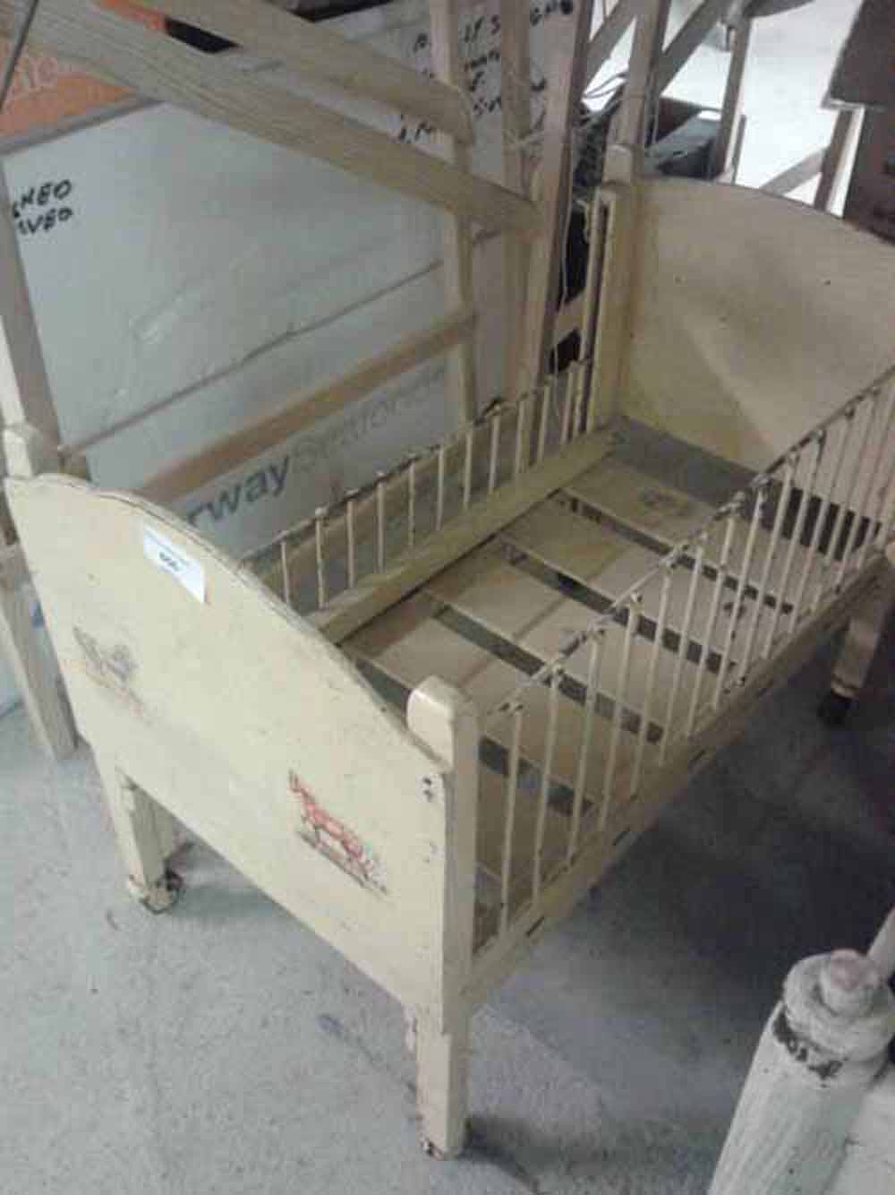 A vintage child`s doll`s cot - wooden framed with metal drop sides