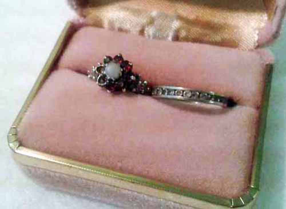 2 silver ladies rings, 1. Flower design (2 red stones missing) & 2. Eternity ring (1 stone