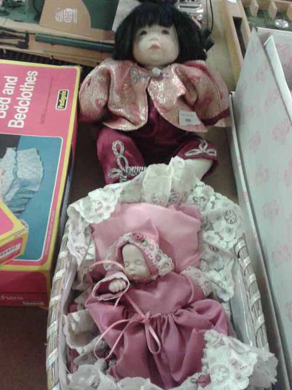 2 artisan hand made dolls, 1 oriental and 1 baby in wicker basket