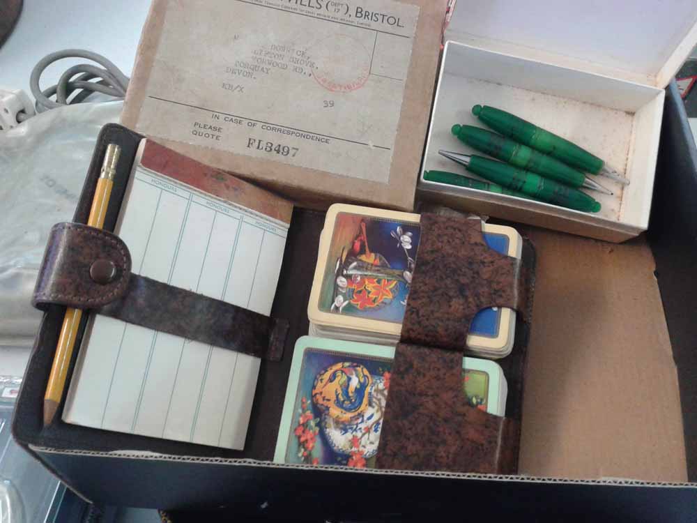 A 1930`s leather bridge playing card set with 2 packs, pencil & scoring pad issued by Wills
