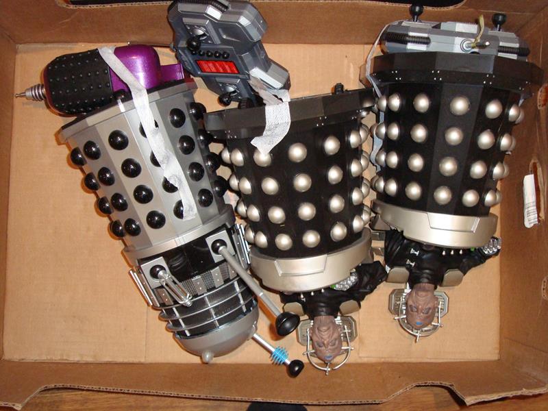 A group of modern radio control toys including two Davros models and a Dalek, all with R/C