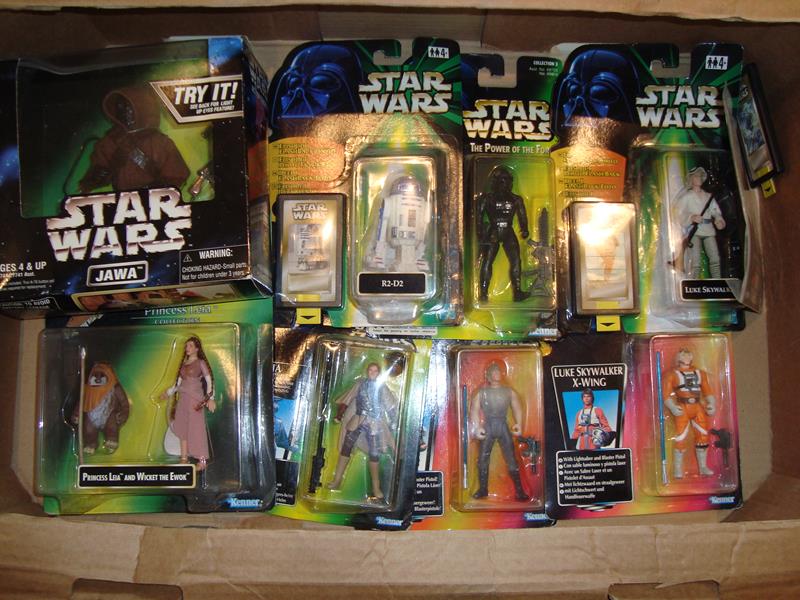 A large tray of mint boxed Star Wars action figures to include a Jawa with light up eyes.