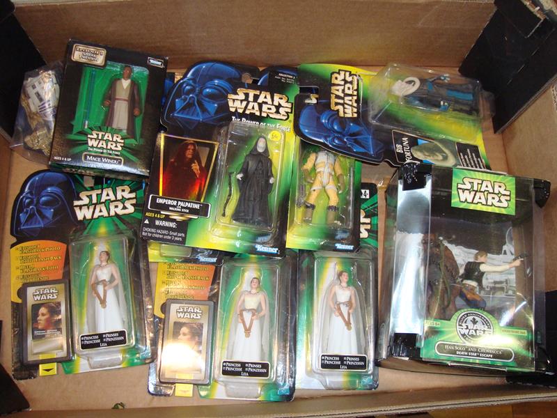 A tray containing a selection of mint boxed Star Wars Power of the Force action figures.


Condition