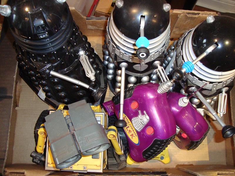 A group of modern radio control toys to include three Daleks and a Wall-E all with R/C transmitters.