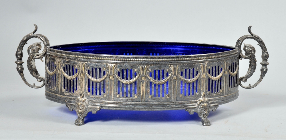 A 19c Adams style two handled serving dish of ovoid form with a blue glass liner, pierced and