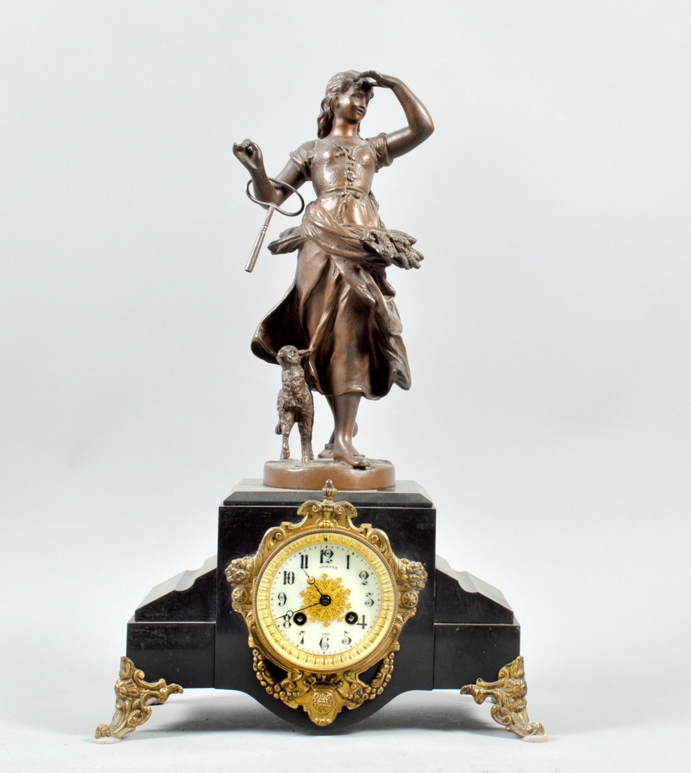 A late 19c French figural mantel clock, the black slate clock case having fancy gilt scroll feet