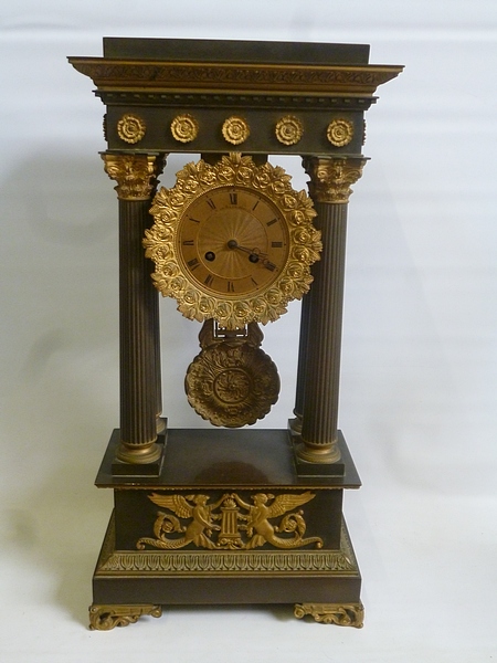 A mid 19c French portico clock, the gilt and bronzed brass case having four fluted Corinthian