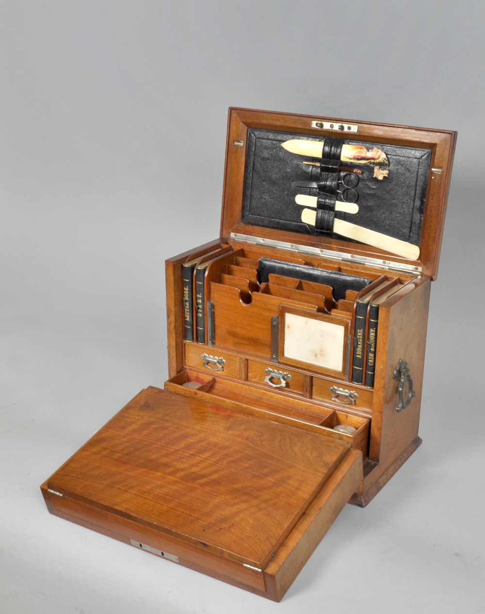 A late Victorian walnut table top writing cabinet . The cabinet contains a fall front writing slope