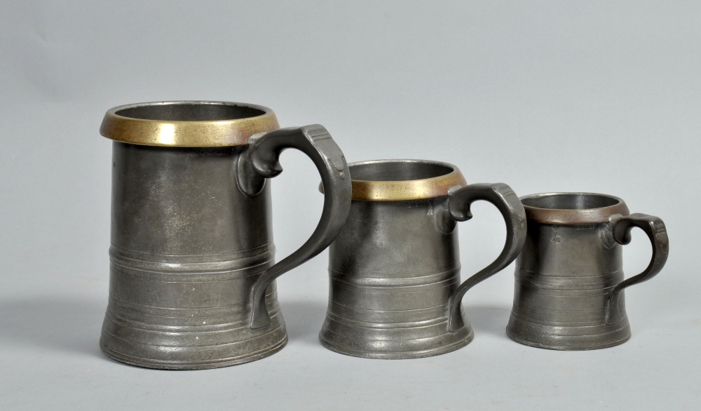 A 19c set of pewter measures, one quart and two half pint, all with stamped capacities and license