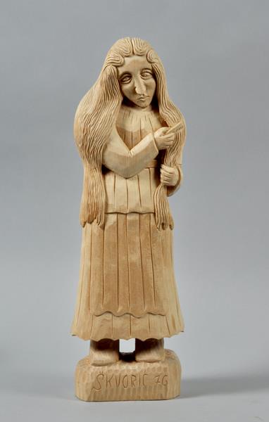Stjepan Skvoric - a carved wood sculpture of a girl combing her hair, inscribed and dated `76, 17.