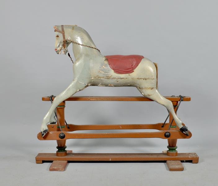 A dapple grey rocking horse with leather harness, the horse 37""w.