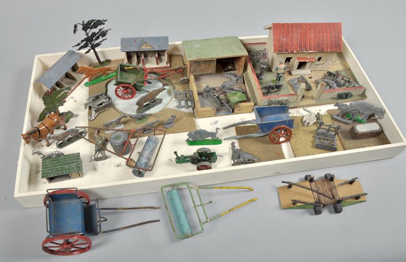 A collection of Britains farm animals, implements, buildings etc including three carts and a