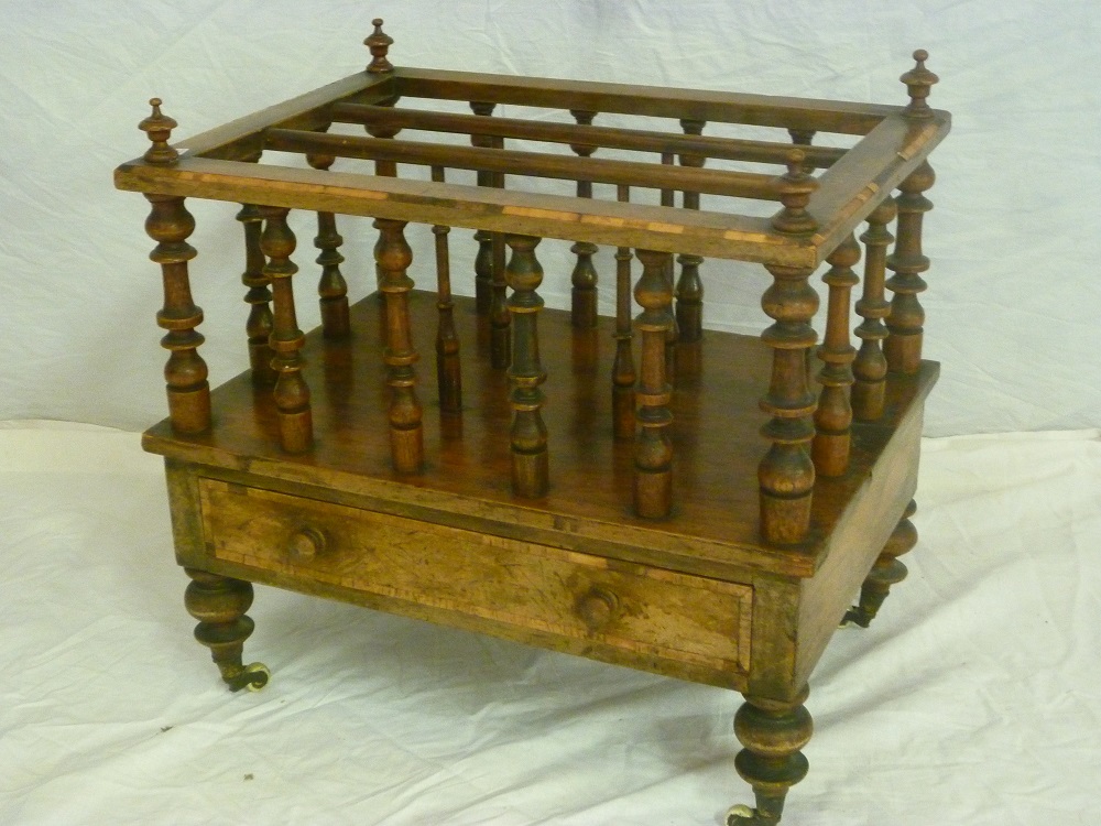 A Victorian inlaid walnut rectangular music Canterbury with turned supports and a single drawer in