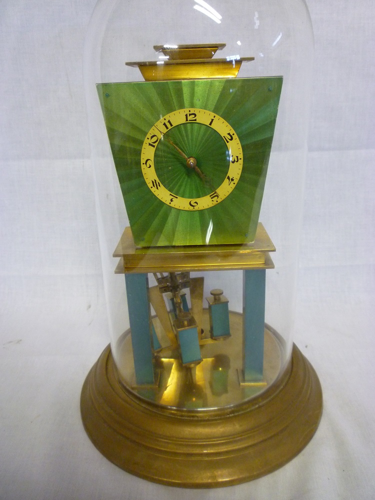 An unusual Art Deco brass and green enamel anniversary-style clock with angular dial and revolving