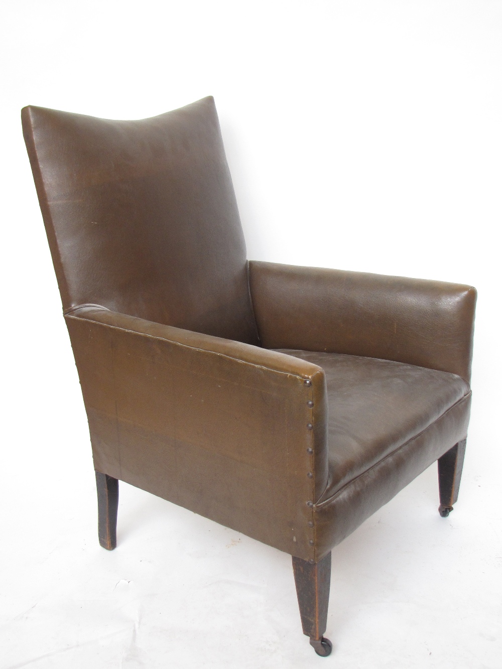 An Edwardian armchair upholstered in faux leather with loose cover.