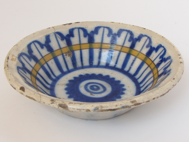 A possibly 18th century Spanish tin glazed faience bowl. 9 1/2" diameter. Repaired.