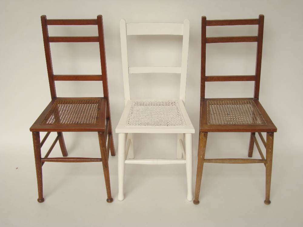 A pair of Edwardian walnut bedroom chairs with caned seats and another white painted (3).