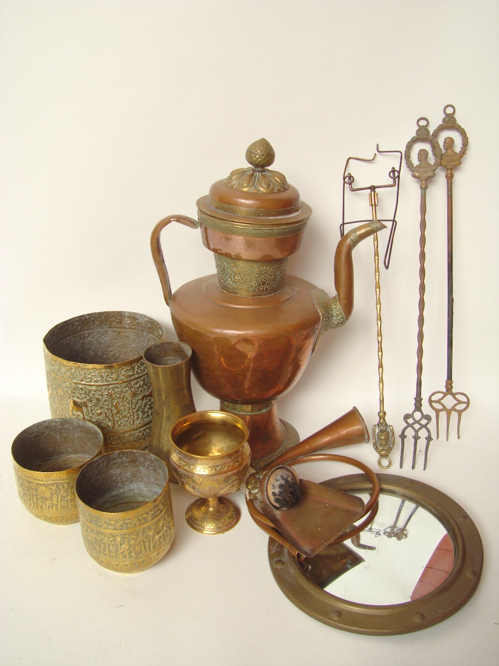 Three 19th Century Indian embossed brass planters, an Arabian copper ewer etc.