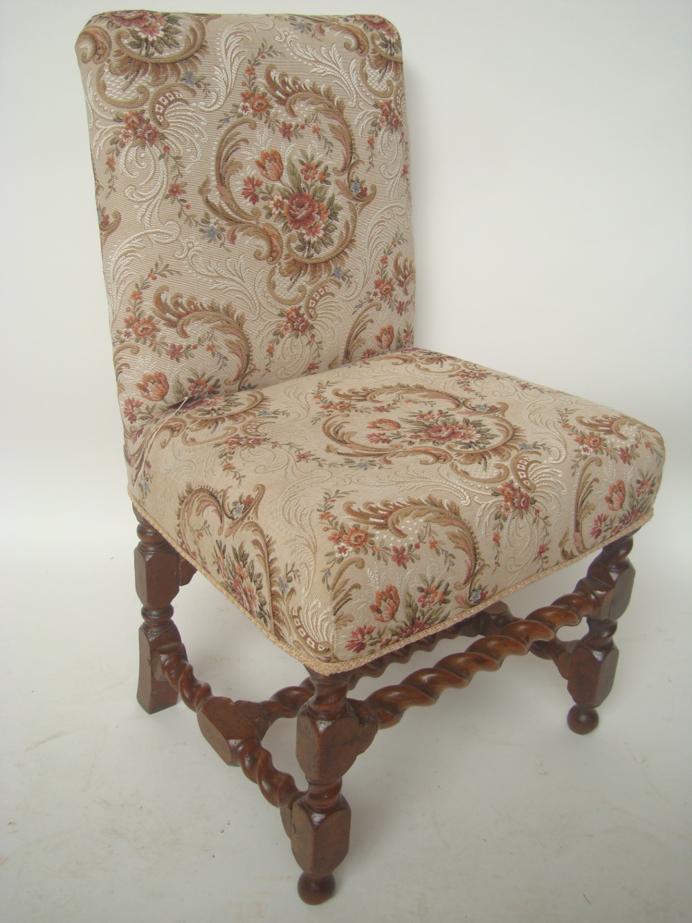 A late 17th/18th century French walnut side chair.
With upholstered back and stuff over seat on