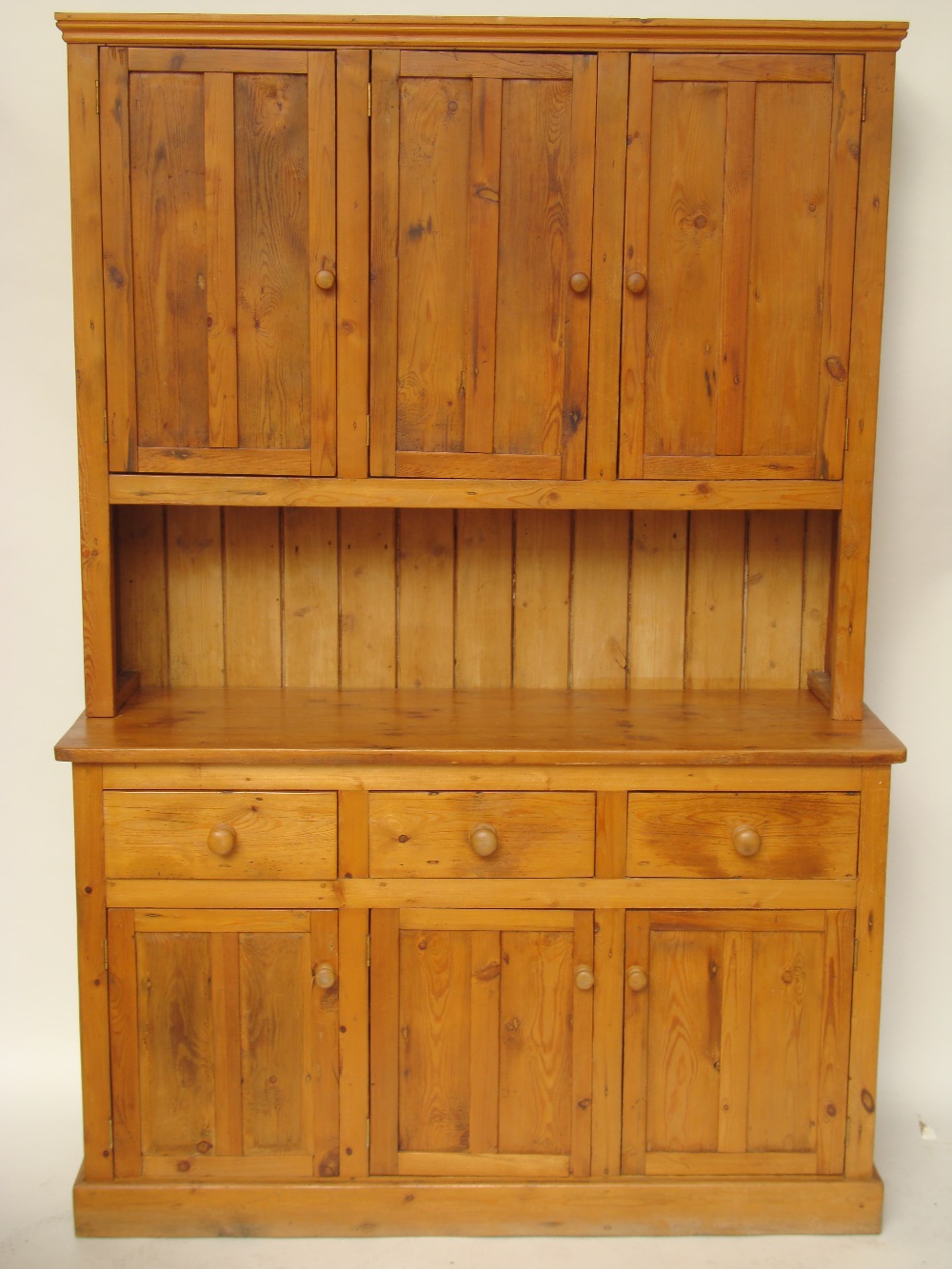 Railway interest.  A pine kitchen dresser, the upper section with three panelled cupboard doors on a