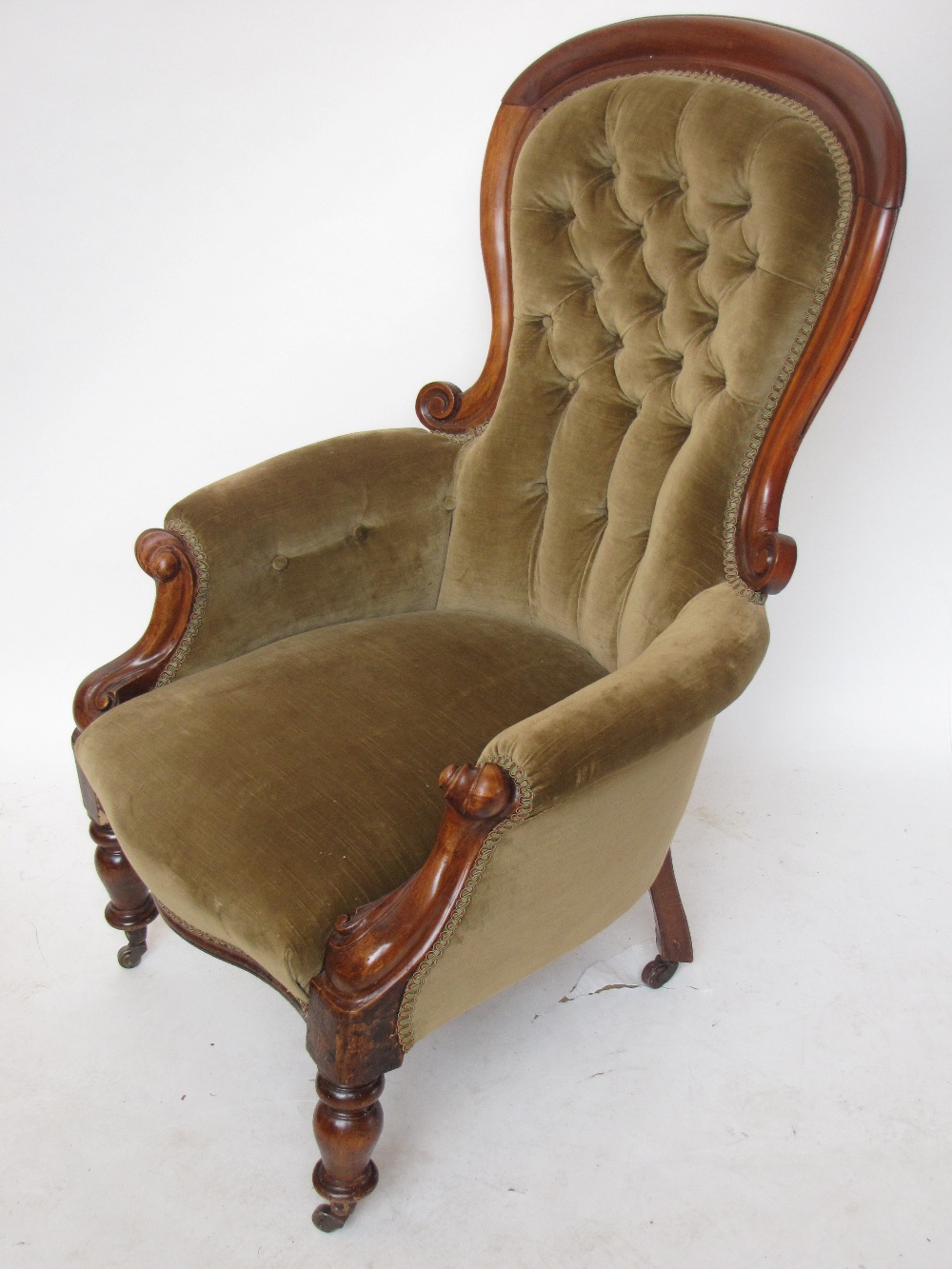 A Victorian  mahogany framed buttonback upholstered armchair.