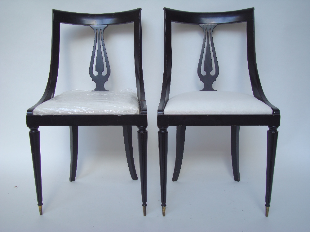 A pair of ebonised Biedermeier style side chairs with drop in seats.