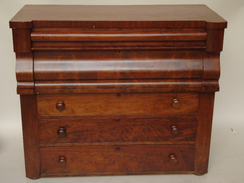 A Victorian mahogany chest of drawers with secret frieze drawer over four drawers of varying