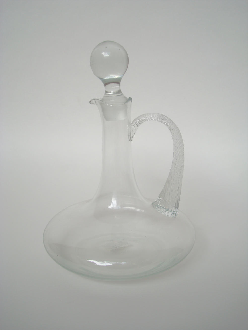 A late Victorian glass claret jug and stopper with twisted loop handle.