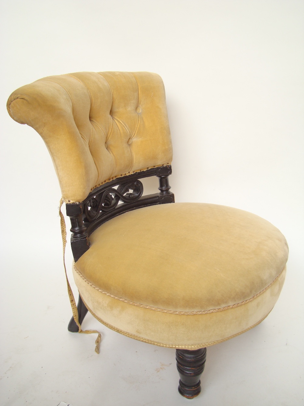 A Victorian upholstered bedroom chair with ebonised frame.