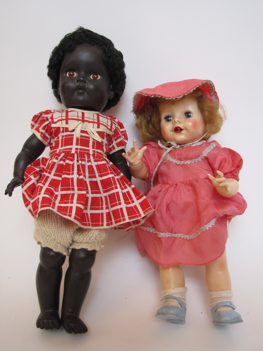 A Pedigree black rubber doll with go-to-sleep eyes and original clothes, together with another