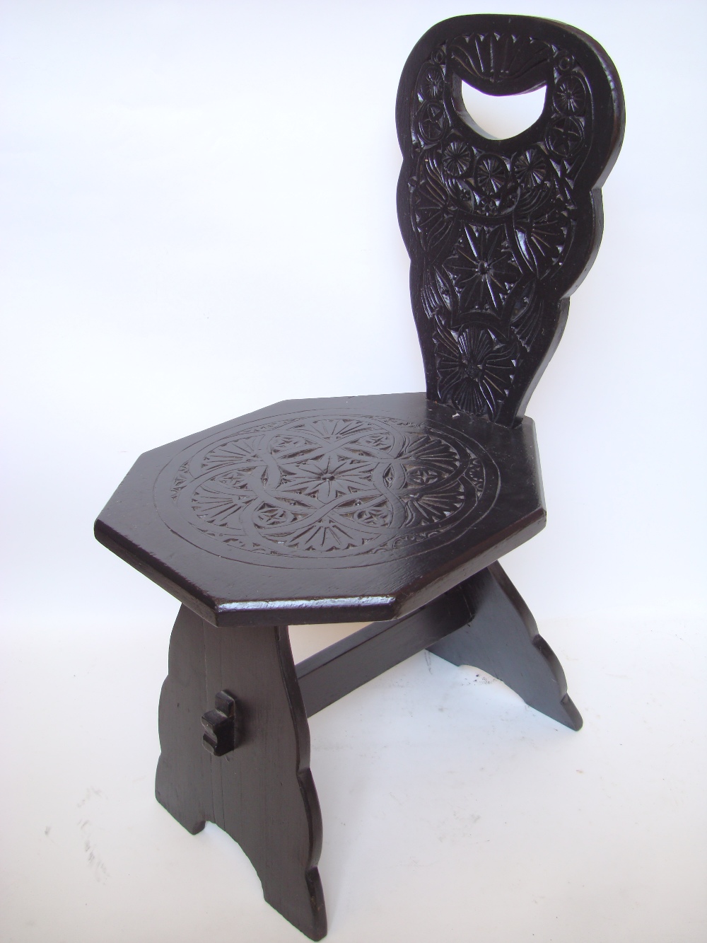 A carved spinning chair.