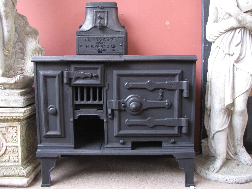 A late 19th Century cast iron stove, with plaque 'The Stoodwell' Right H.E Olby & Co Lewisham S.E,