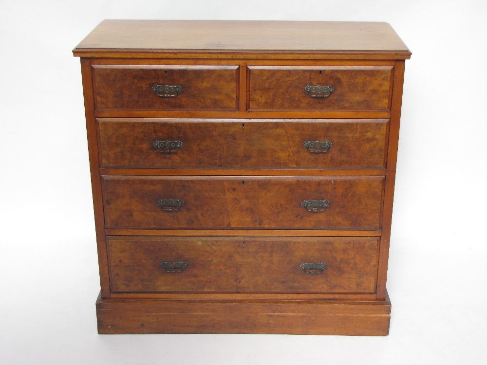 An Edwardian walnut chest of drawers, with moulded edge top, over two short and three long graduated