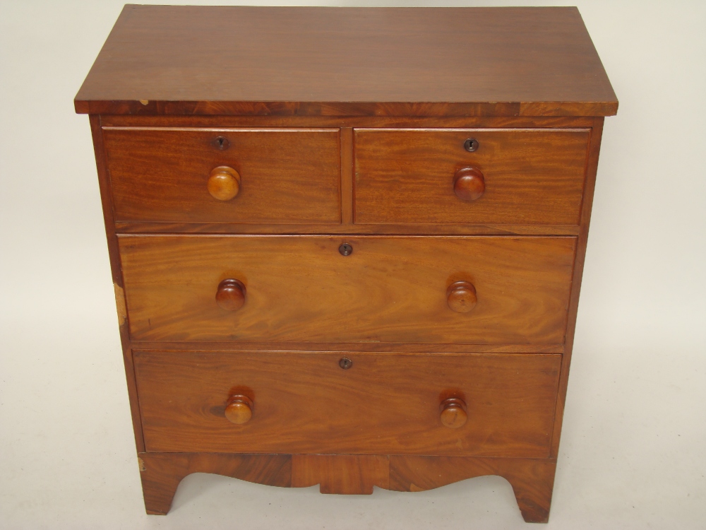 An early 19th Century mahogany chest of drawers, with two short and two long graduated drawers