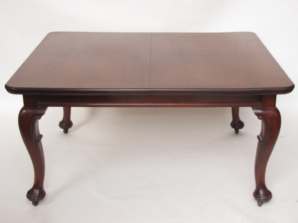 WITHDRAWN.  A large Victorian mahogany extending dining table, the top with rounded corners and