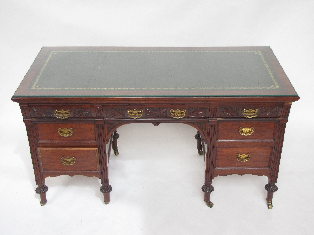 A late Victorian Shollbred & Co walnut twin pedestal desk, the rectangular top with moulded edge