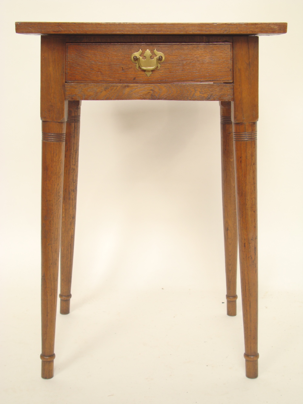 A George III oak side table, the rectangular two plank top over a frieze drawer with replacement