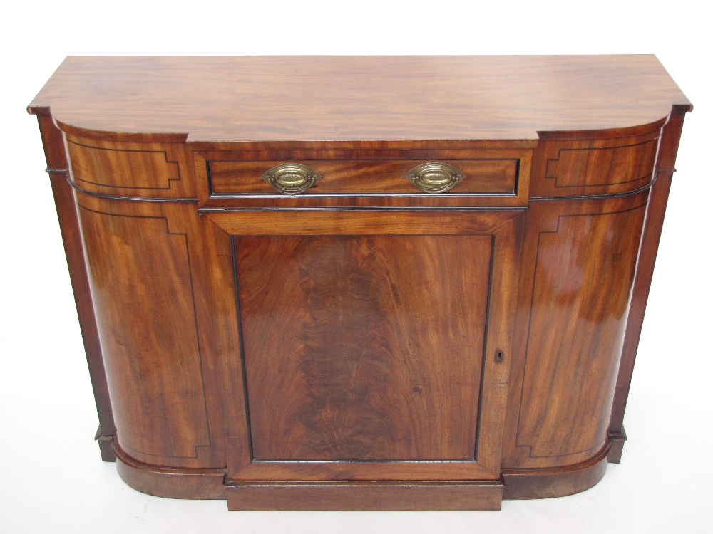 A George III mahogany breakfront side cabinet, the top with moulded edge over central short drawer