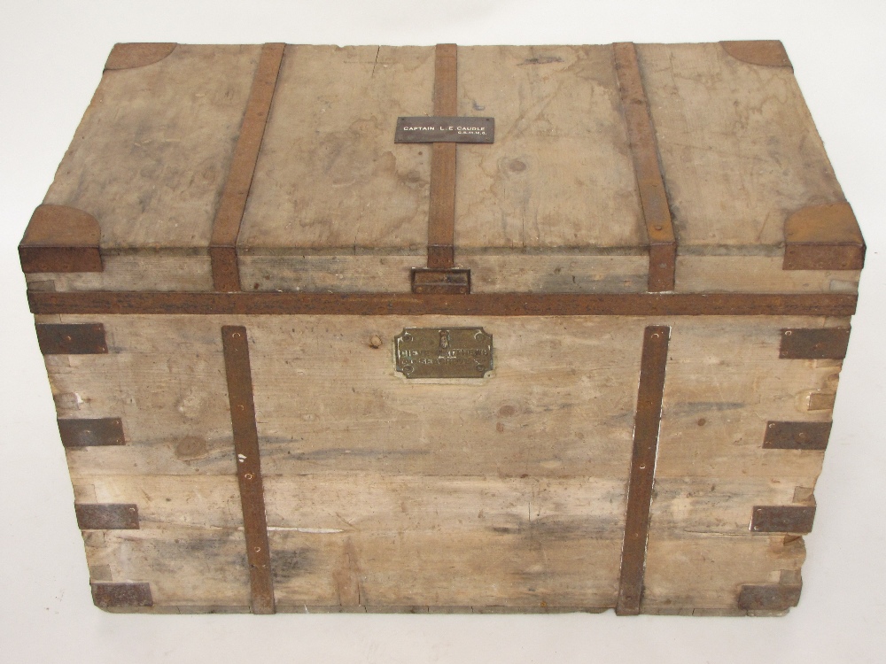 An early 20th Century military iron bound pine travelling trunk, the hinged lid opening to reveal an