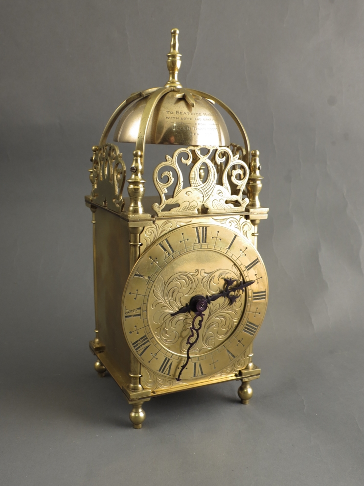 A 20th Century brass lantern clock with French platform movement, dedication inscription to bell