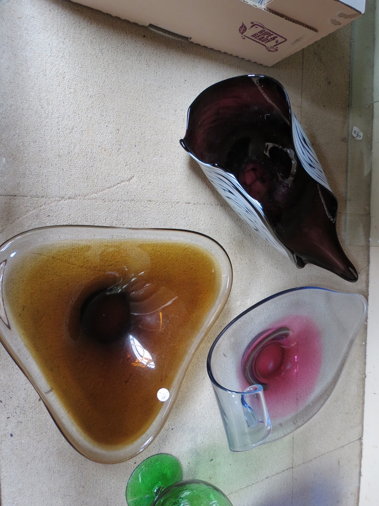 Three Murano free form dishes in amber and in amethyst colours