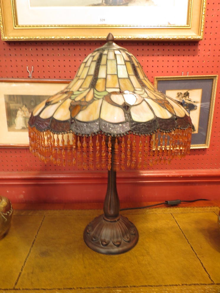 A Tiffany style lead glazed table lamp with beaded fringe