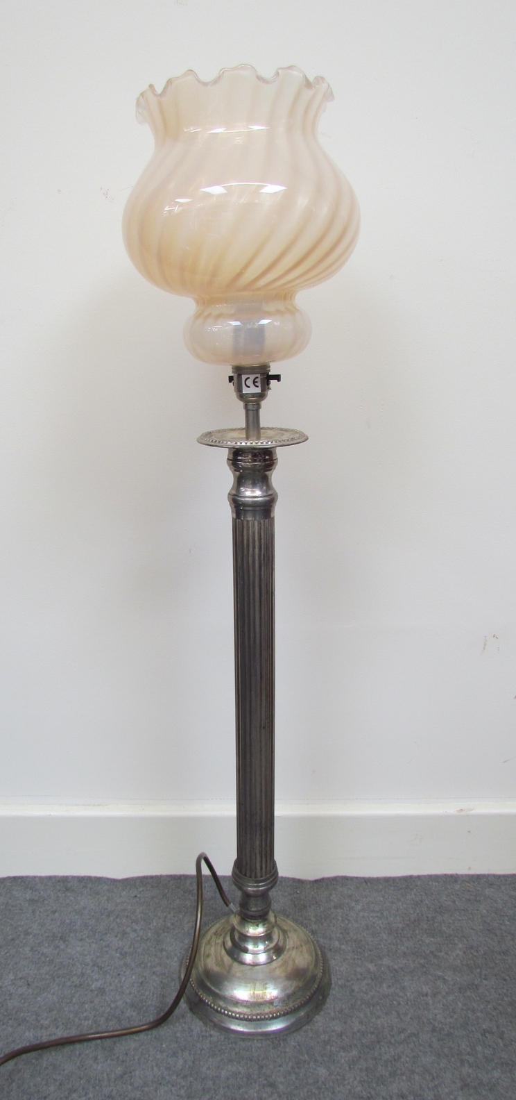 A silver plated Corinthian column table lamp with pink swirl glass shade, 82cm tall