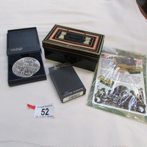 A 1944 Normandie commemorative medal, a boxed Zippo lighter, A reproduction 1944 American cricket