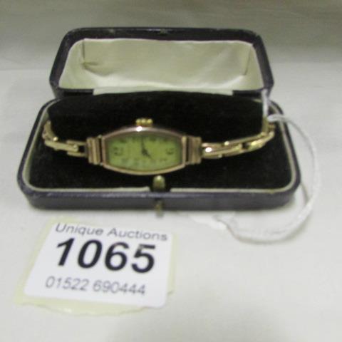 A 1930's 9ct gold watch by Grosvenor with rolled gold strap, in working order and in original box