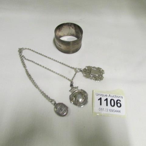 2 silver fobs, a silver locket, a silver chain and a silver napkin ring