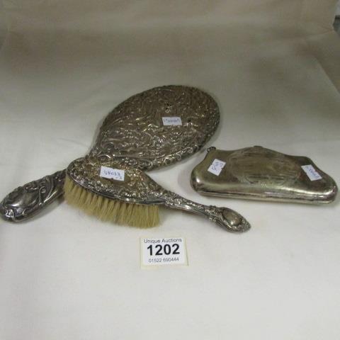 A silver backed brush and mirror together with a silver plated purse
